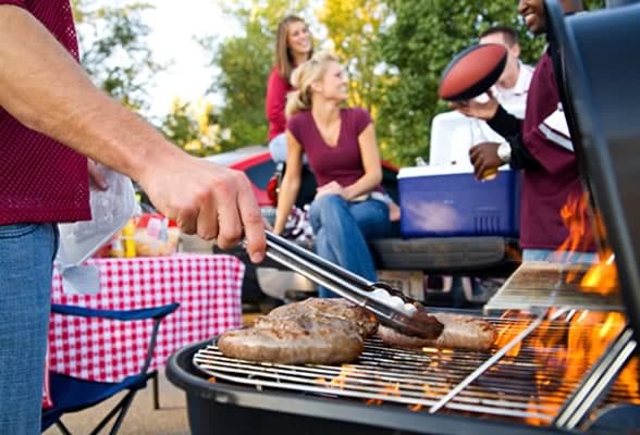 Brats on the Grill at a Tailgate Party