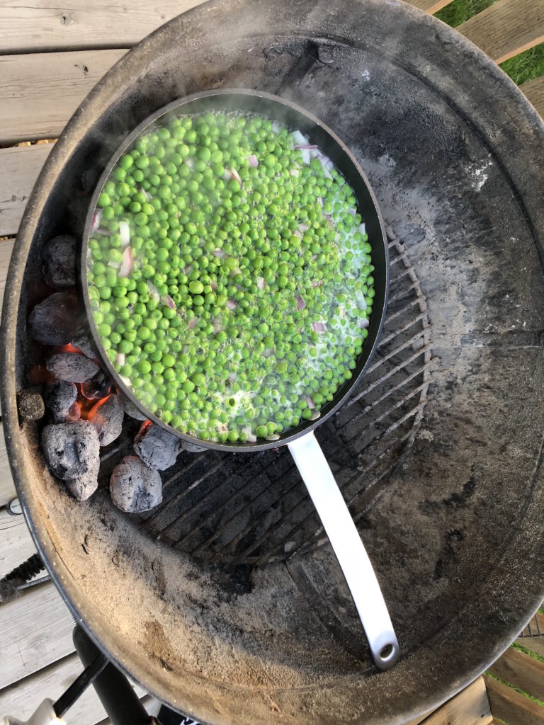 Peas and Shallots in a Skillet on the Grill
